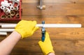 Cutting plastic pipe with scissors, male hands close up