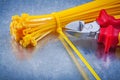 Cutting pliers cable ties on metallic background construction co Royalty Free Stock Photo