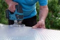 Cutting polycarbonate sheet by cutting machine jigsaw Royalty Free Stock Photo