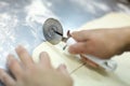 Cutting a puff pastry with a pizza knife Royalty Free Stock Photo