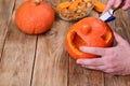 Cutting a pumpkin face. Making a pumpkin lantern for Halloween.