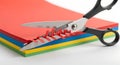Cutting Through the Red Tape: Scissors Slicing Colorful Paper Stack Royalty Free Stock Photo