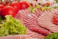 Cutting sausage and cured meat with a parsley Royalty Free Stock Photo