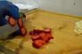 Cutting strawberries and banana on wooden table Royalty Free Stock Photo