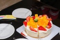 Cutting strawberry & mango birthday cake