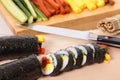 Cutting sushi with ingredients and knife background Royalty Free Stock Photo