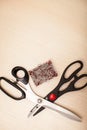 On the cutting table lie scissors and pins. Work place of seamstress. topp view, place for text Royalty Free Stock Photo