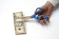 Cutting a ten dollars with scissors Royalty Free Stock Photo