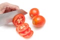 Cutting tomatoes into small slices on white background isolated
