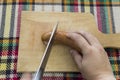 Cutting traditional Bulgarian sausage with herbs and spices call Royalty Free Stock Photo