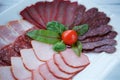 Cutting of various types of meat and sausages on a plate Royalty Free Stock Photo