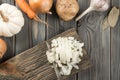 Cutting white spicy onion with knife into cubes on kitchen wooden board. White diced onion. Flat lay view. Healthy food.