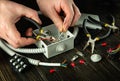 Cutting a wire in a gray junction box with Diagonal pliers. Electrical connection in the workshop of a professional master Royalty Free Stock Photo