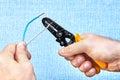 Cutting wire insulation with hand tool Royalty Free Stock Photo