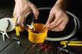 Cutting the wire in the yellow junction box. Electrical connection in the workshop of a professional master electrician. Close-up Royalty Free Stock Photo