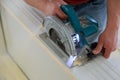man using a circular saw for cutting wood door construction and home renovation, repair tool