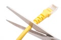 Cutting a yellow network cable with scissors