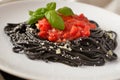 Cuttlefish ink spaghetti under tomato sauce Royalty Free Stock Photo