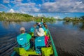 CUYABENO, ECUADOR - NOVEMBER 16, 2016: Unidentified people travelling by boat into the depth of Amazon Jungle in