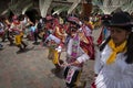 A group of people wearing traditional clothes and masks during the Huaylia on Christmas day at the Plaza de Armas square in the ci