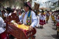 A man holding a cradle with baby Jesus and wearing traditional clothes during the Huaylia on Christmas day at the Plaza de Armas s