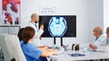 Cvalified bearded head doctor explaining brain structure using monitor Royalty Free Stock Photo