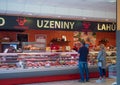 Cvikov, CZECH REPUBLIC - MAY 24, 2019: Frontal view of butcher shop in penny market with female butcher showing meat to Royalty Free Stock Photo