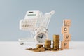 CVP text ,cost, volume, profit , and graph on wooden cube blocks, with stack of coins , blurred clock ,calculator, shopping cart. Royalty Free Stock Photo