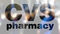 CVS Health logo on a glass against blurred crowd on the steet. Editorial 3D rendering