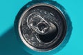 Cyan blue open soda can in shadow and light covered with water drops Royalty Free Stock Photo