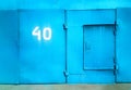 Cyan closed garage door with numer 40 city background