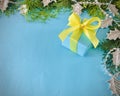 A cyan gift boxes tied with yellow ribbon on an aqua background. Royalty Free Stock Photo