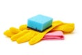 Kitchen sponge, yellow household gloves and red surface cleaning wipe isolated on white background