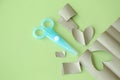 Cyan Plastic children safety scissors on table with brown paper in different shape Royalty Free Stock Photo