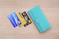 Cyan wallet and credit cards on wood table background Royalty Free Stock Photo