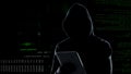 Cyber attack with unrecognizable hooded hacker using tablet computer, cybercrime Royalty Free Stock Photo