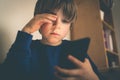 Cyber bullying concept - depressed boy with phone and negative comments Royalty Free Stock Photo