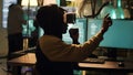 Cyber criminal using virtual reality haeadset to hack computer firewall