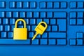 Cyber data and information security idea. Yellow padlock and key and blue keyboard. Computer, information safety, confidentiality