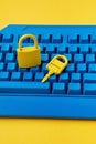 Cyber data and information security idea. Yellow padlock and key and blue keyboard. Computer, information safety, confidentiality