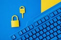 Cyber data and information security idea. Yellow padlock and key and blue keyboard. Computer, information safety, confidentiality