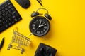 Cyber monday concept. Top view photo of alarm clock keyboard computer mouse shopping cart pencils and giftbox with ribbon bow on Royalty Free Stock Photo