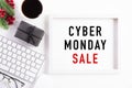 Cyber Monday Sale text on white picture frame with keyboard mouse coffee cup, gift box and Christmas tree decoration, red berries Royalty Free Stock Photo