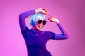 Cyber punk girl concept, asian woman in purple sweatshirt blue color short hair style wearing sunglasses posing dancing on the Royalty Free Stock Photo