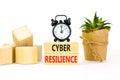 Cyber resilience symbol. Concept word Cyber resilience typed on wooden blocks. Beautiful white table white background. Black alarm Royalty Free Stock Photo