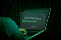 Hacker initiating file-transfer with binary code background. Royalty Free Stock Photo