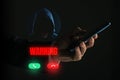 Cyber Security Warning: Man Receiving a Threatening Call from an Unknown Hooded Figure on a Smartphone Device Royalty Free Stock Photo