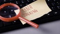 Cyber Stalking Note and Magnifying Glass on Keyboard: Online Crime, Threat, and Internet Security Royalty Free Stock Photo