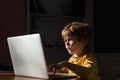 Cybercrime concept. Male hacker working on a computer in Data center filled with monitor screens. Kids using laptop in