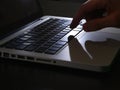 Cybercrime - deep shadow on keyboard